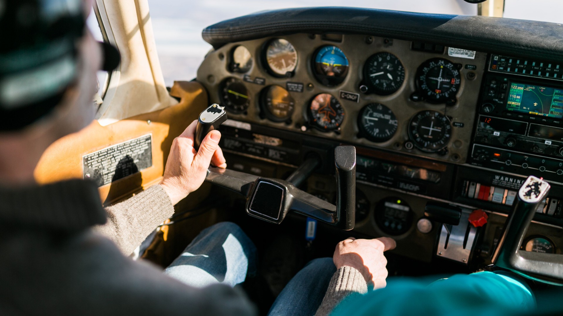 Flight instructor and student inside small Piper aircraft